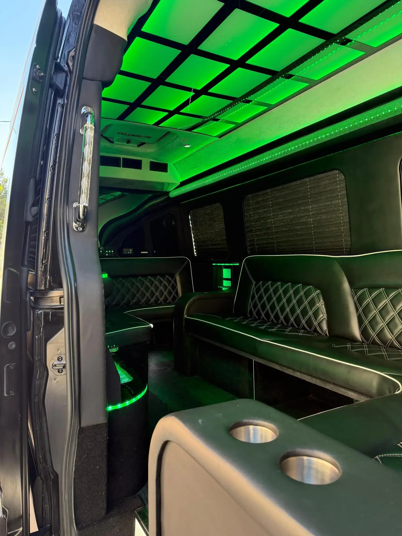 Black Party Limo Sprinter Van parked at night with LED lighting visible