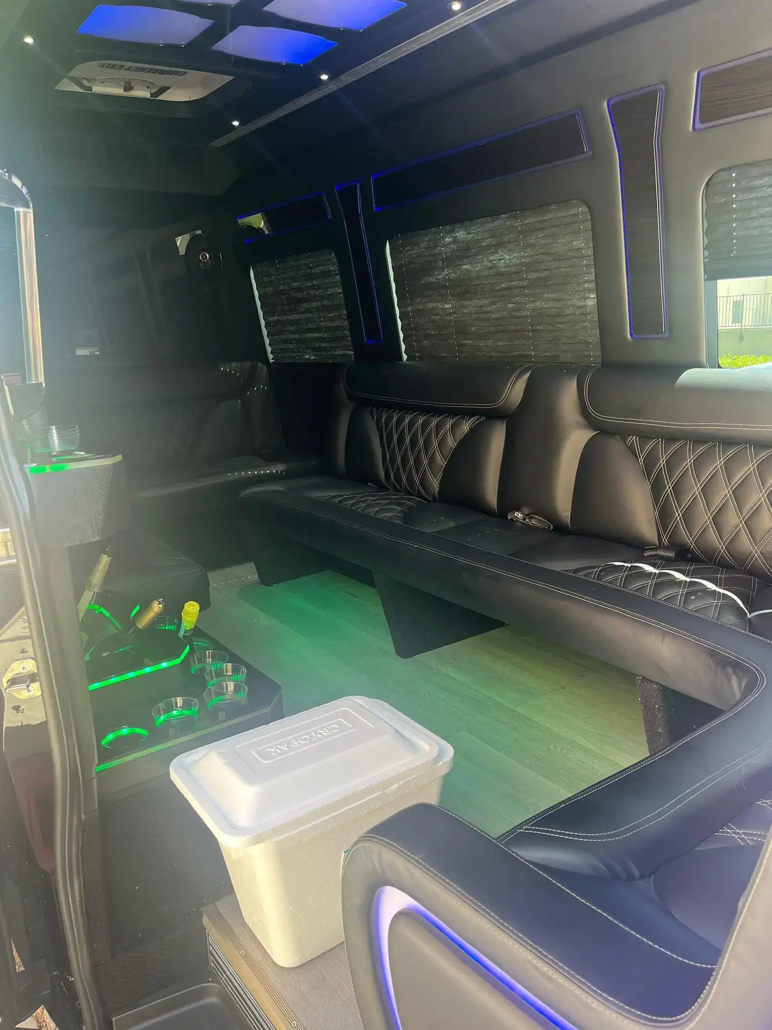 Interior of Black Party Limo Van showing leather seating and LED lighting